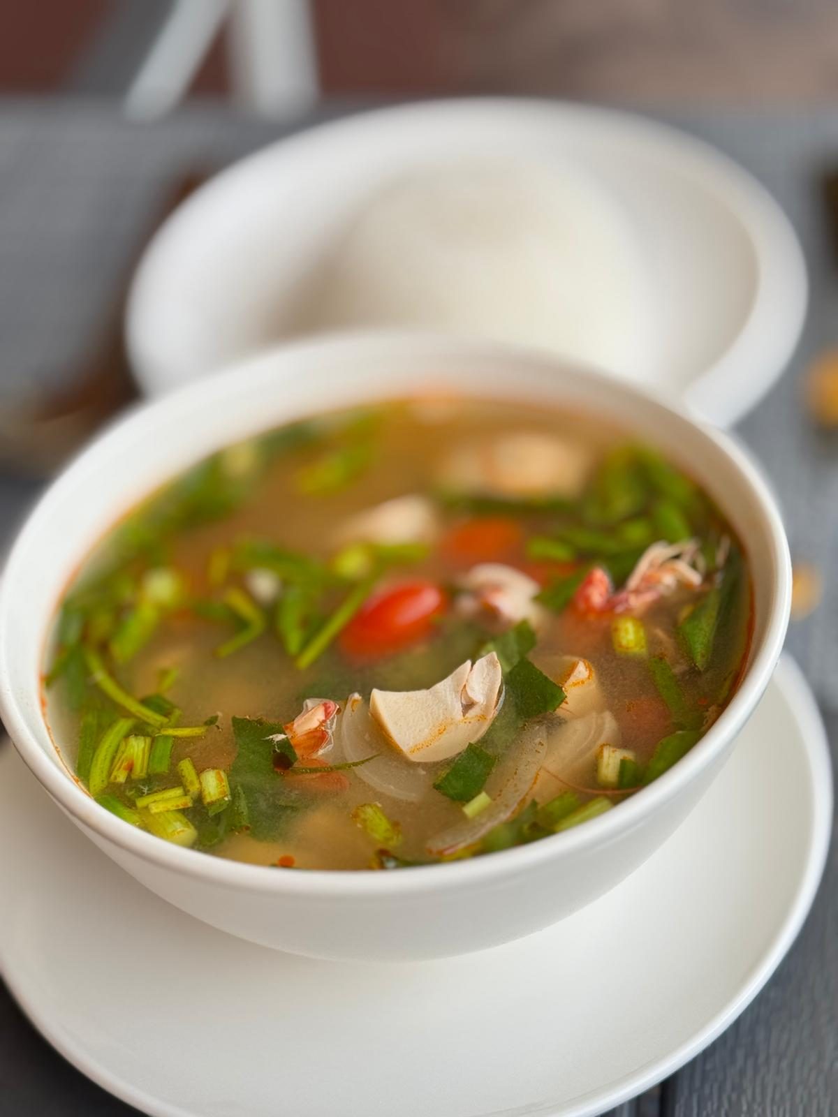 Tom yum soup with prawns, mushrooms and lemongrass, served with rice